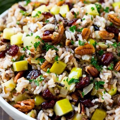 A serving bowl of rice pilaf made with wild rice, apples, cranberries and pecans.